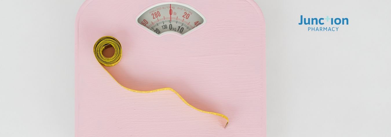 Weight loss pink scales and tape measure