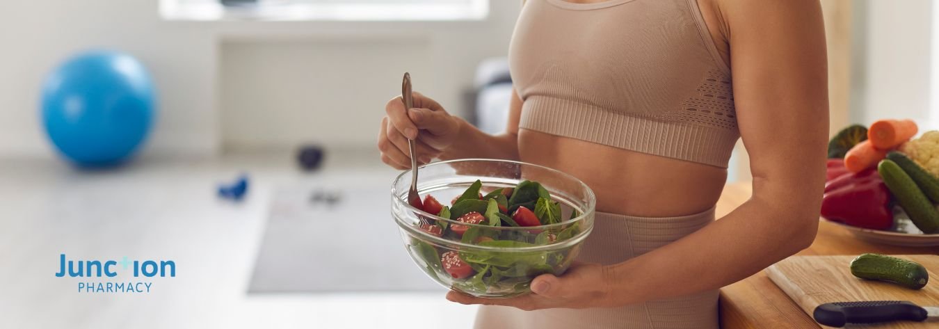 Woman eating healthy food in gym gear