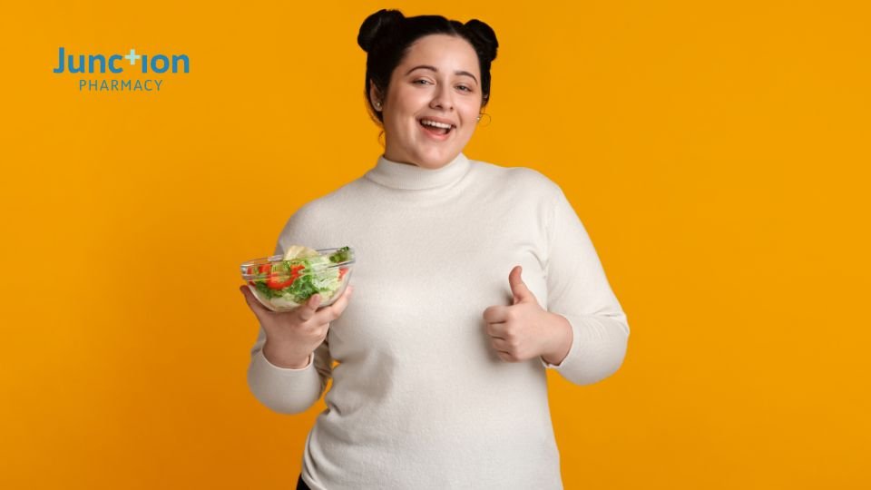 Woman posing with a bowl of salad to represent weight loss