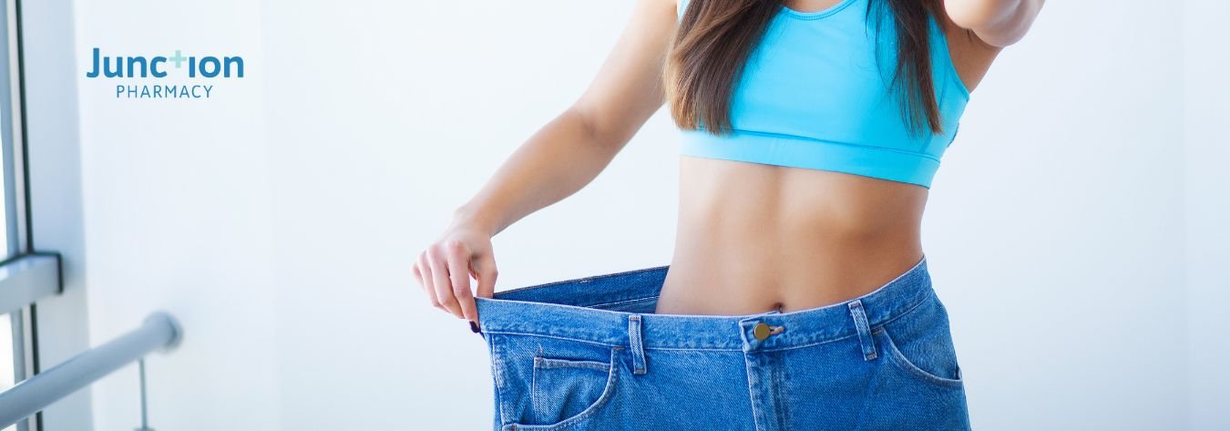 Woman who has lost weight in large jeans