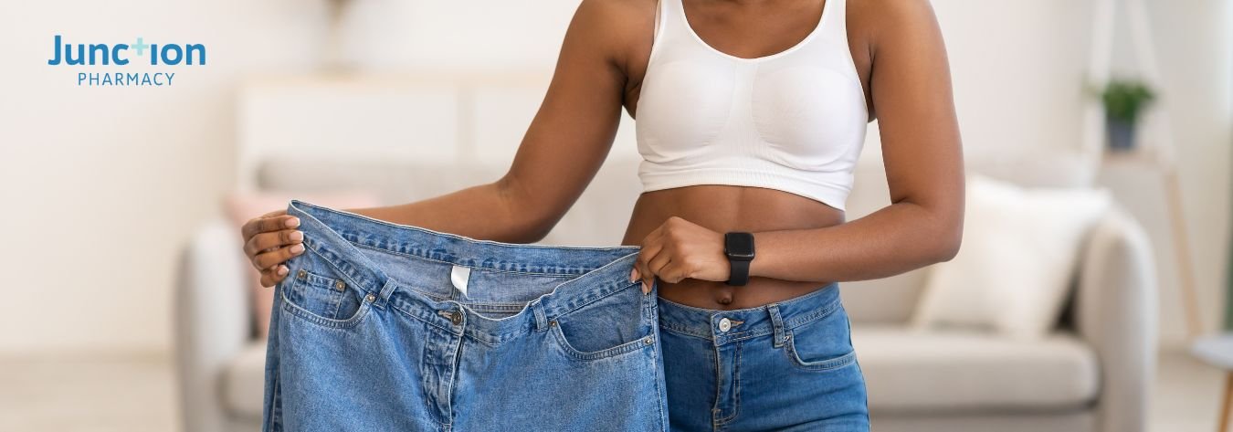 Holding old jeans to highlight weight loss