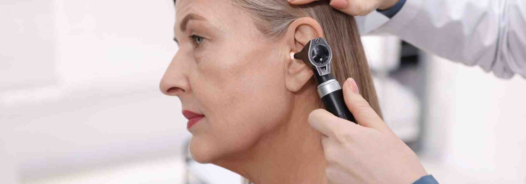 Woman having a professional earwax check 