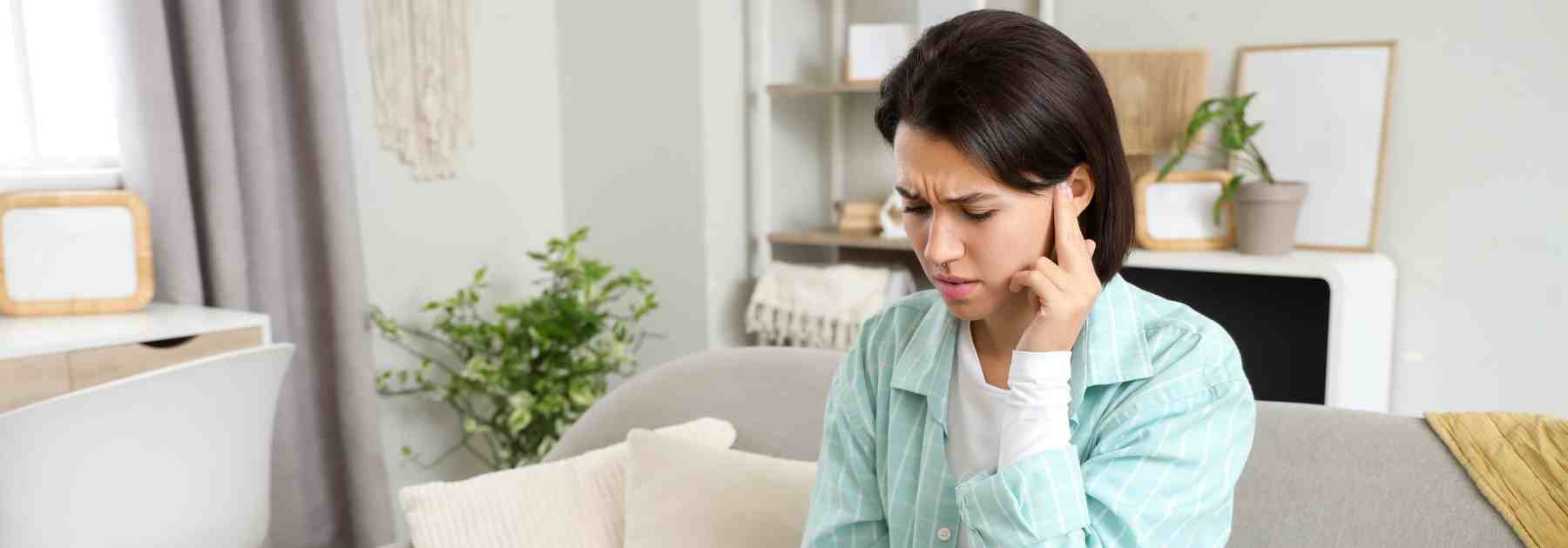 Woman with blocked ears from earwax