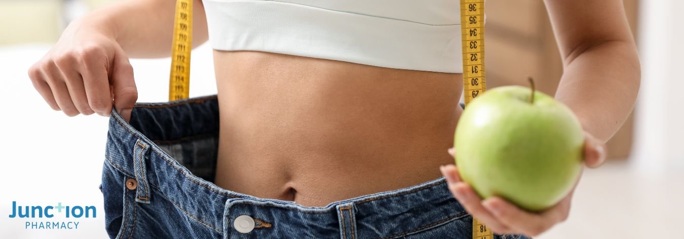 Woman holding apple and measuring tape to symbolise weight loss