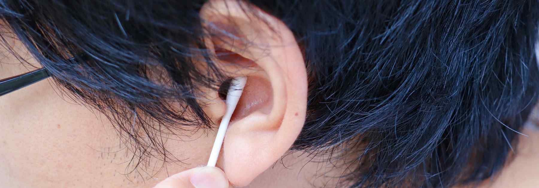 Removing earwax with a cotton bud