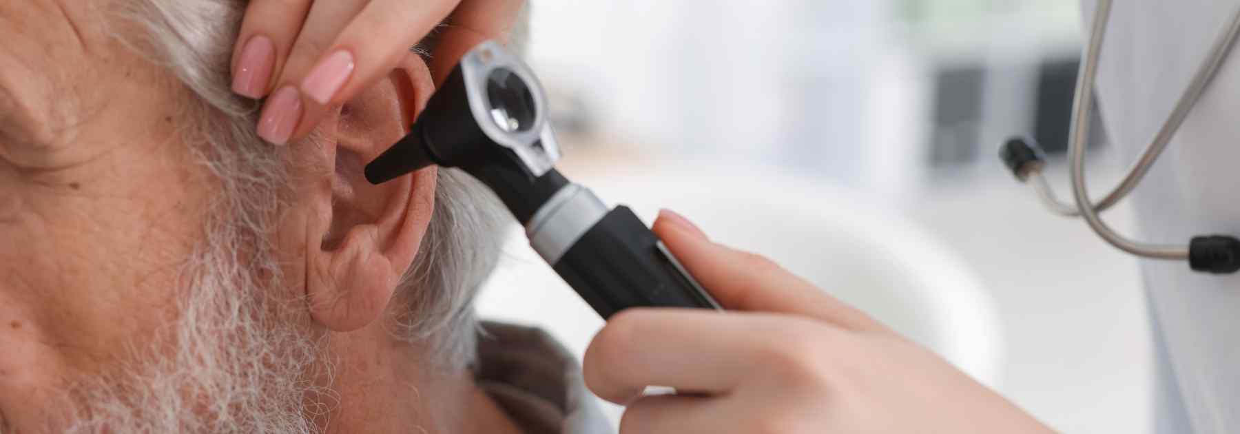 Elderly man getting ear check