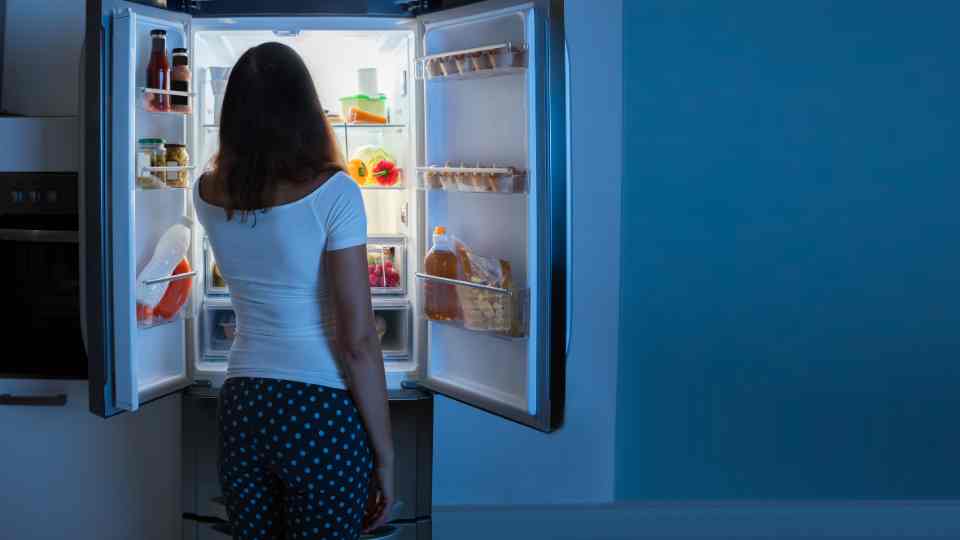 Woman looking in fridge for Wegovy