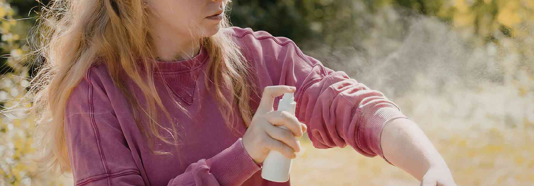 Woman using insect spray