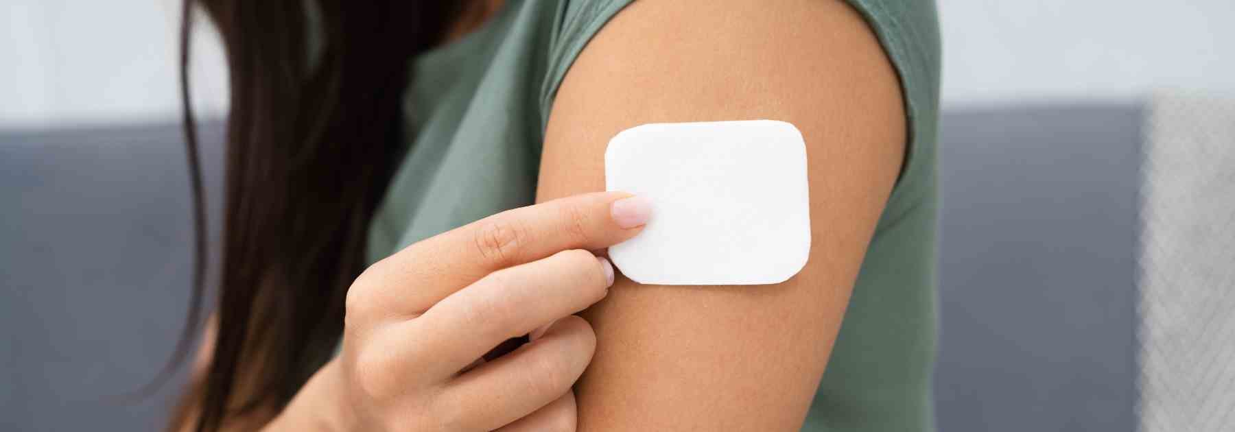 Weight loss patch being applied to arm
