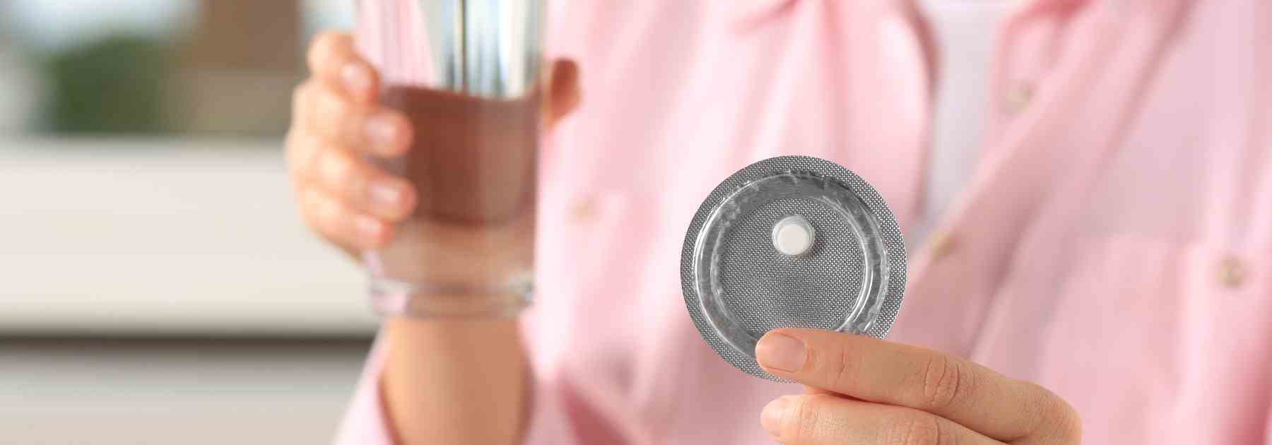 Woman holding an emergency contraceptive pill