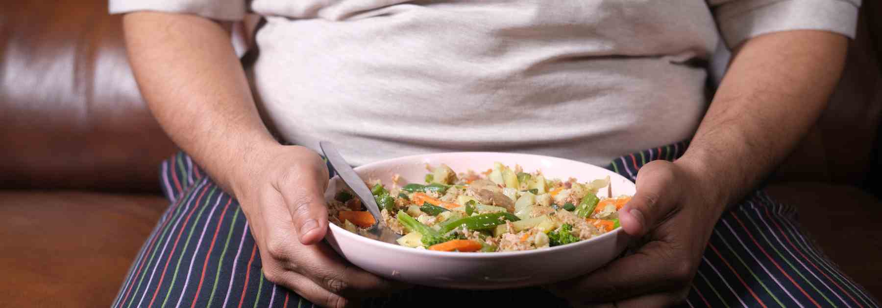 Obese person eating healthy food