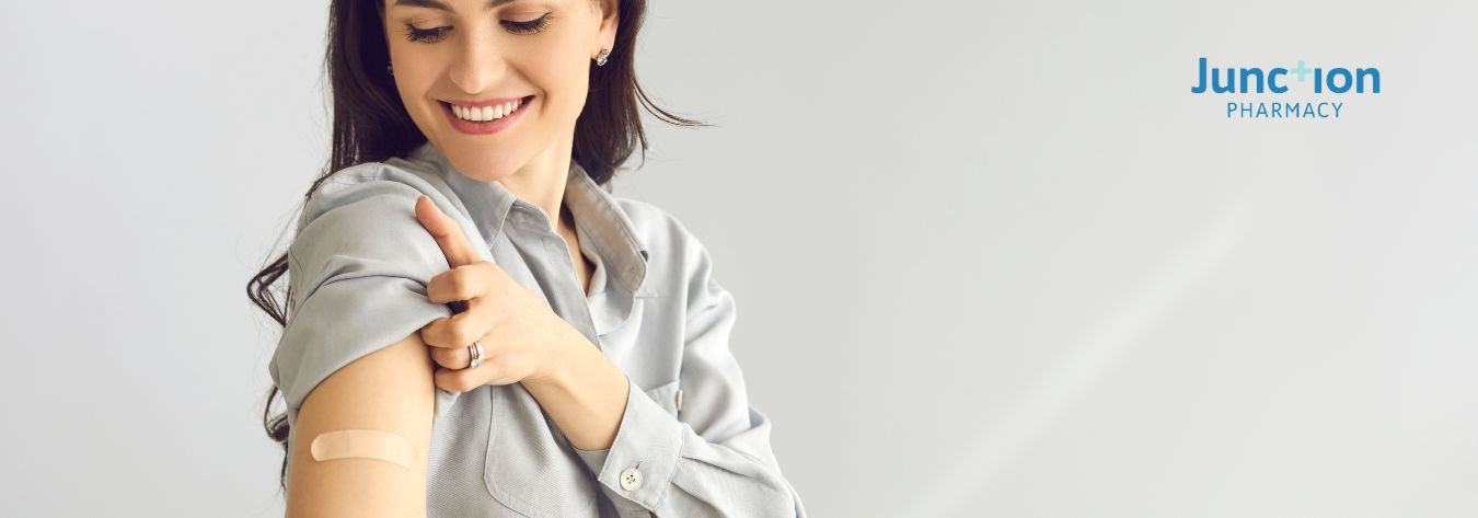 Woman with a plaster on her arm after getting vaccinated
