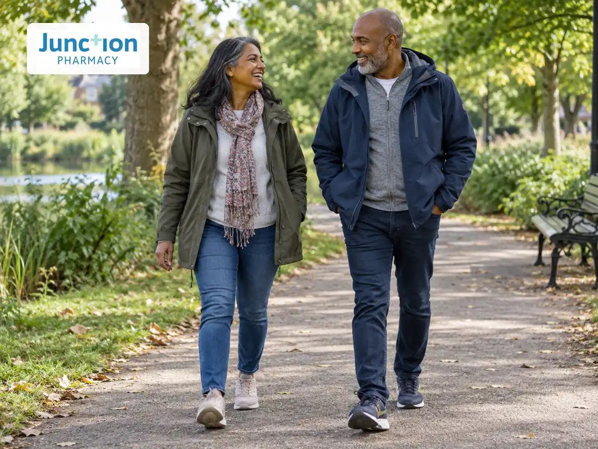 Two adults walking together on a leafy London park path