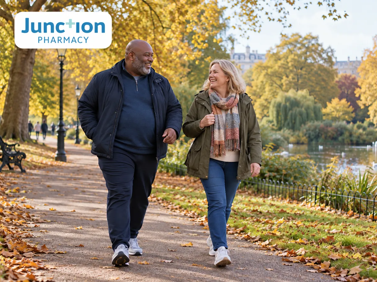 Two adults walking together along a leafy park path