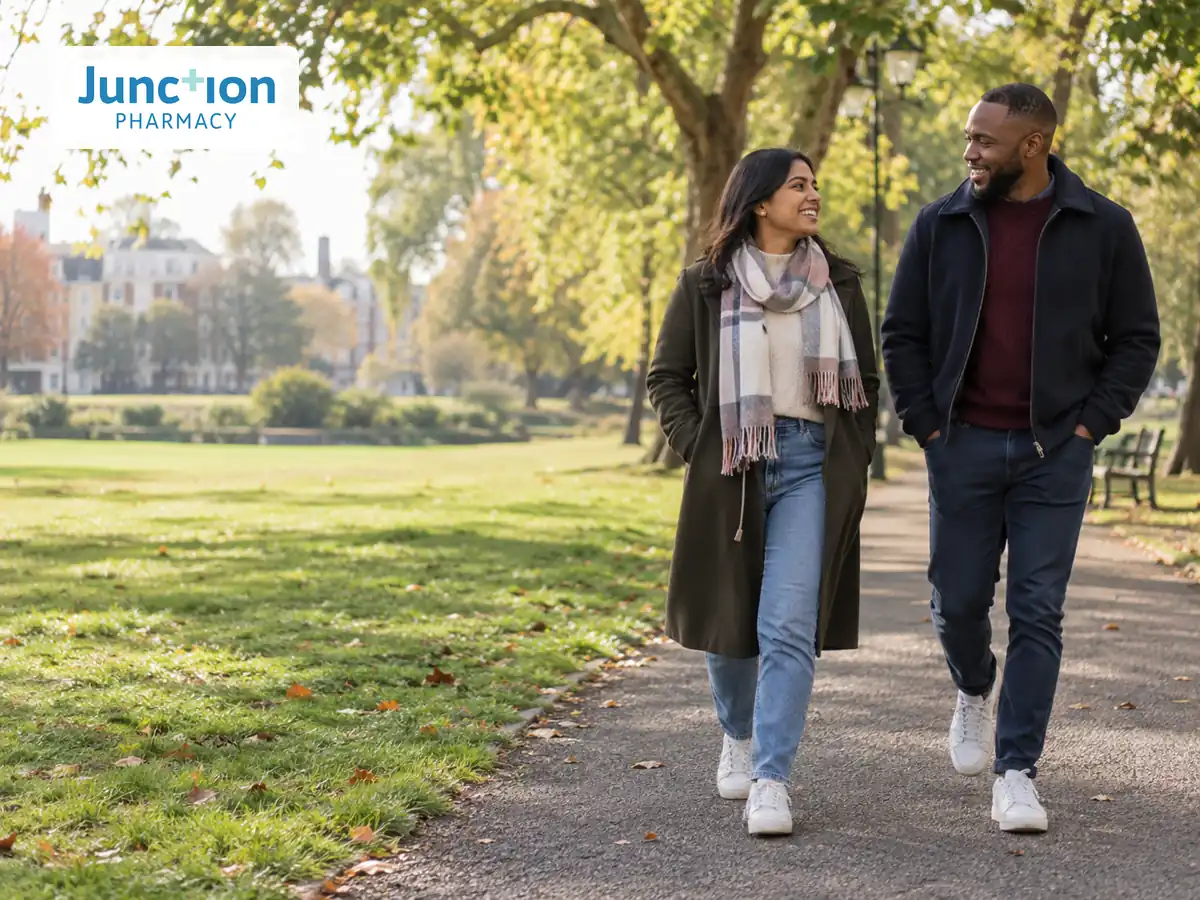 Two adults walking together along a park path